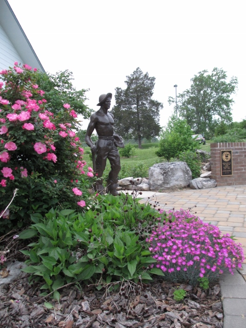 The CCC Worker Statue standing at the center of the Commemorative Wall, Edinburg, Virginia