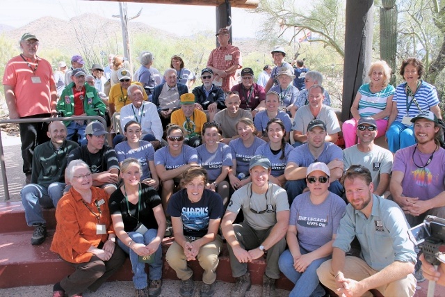 CCC Legacy members and young conservation corps crew members seated together on stone steps at a national gathering